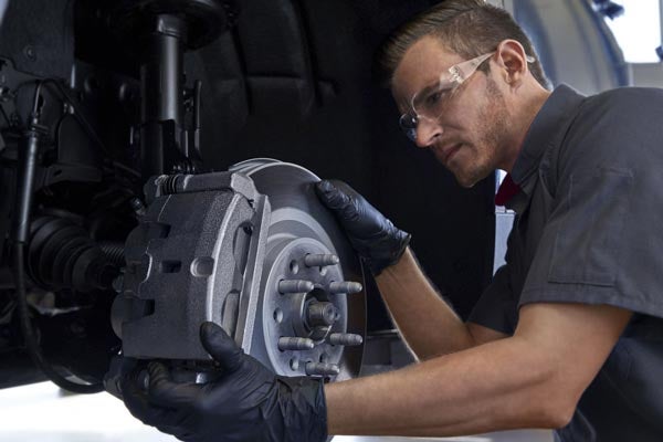A Certified Technician adjusts the rotor and brakes