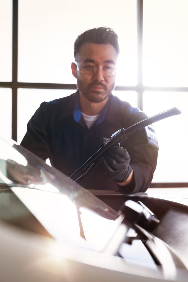 Cadillac Certified Service Technician Inspecting Windshield Wipers on a Vehicle