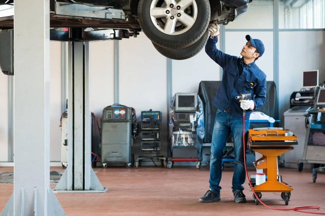 Service Technician working on a lifted vehicle